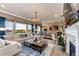 Bright, open-concept living room with hardwood floors, a fireplace, and large windows with beautiful views at 2115 Holmby Ct, Castle Rock, CO 80104