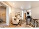 Cozy loft area with comfortable seating, a decorative rug, and access to other rooms at 2115 Holmby Ct, Castle Rock, CO 80104