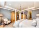 The main bedroom shows tray ceilings, a chandelier, and a wardrobe at 2115 Holmby Ct, Castle Rock, CO 80104