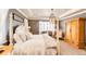 This main bedroom features a four-poster bed, a chandelier, and an armoire at 2115 Holmby Ct, Castle Rock, CO 80104