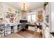 Bright craft room with natural light, custom storage, and a charming chandelier at 2115 Holmby Ct, Castle Rock, CO 80104