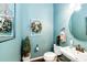 Charming powder room with light blue walls, decorative accents, and modern fixtures at 2115 Holmby Ct, Castle Rock, CO 80104