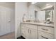 Bright bathroom featuring a single sink vanity with white cabinets, stone countertop, and a modern design at 74 Blue Heron Dr, Greenwood Village, CO 80121