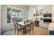 Cozy dining area featuring a modern light fixture and views into the yard at 74 Blue Heron Dr, Greenwood Village, CO 80121