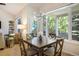 Open dining space boasting natural light and outdoor scenery, with a glimpse of the living area at 74 Blue Heron Dr, Greenwood Village, CO 80121