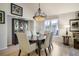Inviting dining room with hardwood floors, statement lighting, and bright natural light at 74 Blue Heron Dr, Greenwood Village, CO 80121