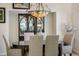 Elegant dining room features a decorative chandelier and a dark wood table with upholstered chairs at 74 Blue Heron Dr, Greenwood Village, CO 80121