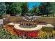 The community entrance features a stone monument, decorative metalwork, and a colorful flower display at 74 Blue Heron Dr, Greenwood Village, CO 80121