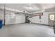 Spacious two-car garage with epoxy flooring, storage solutions, and ample room for parking and projects at 74 Blue Heron Dr, Greenwood Village, CO 80121