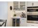 Well-appointed kitchen area with stainless steel appliances, wine fridge, and decorative backsplash at 74 Blue Heron Dr, Greenwood Village, CO 80121