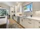 Updated kitchen with white cabinetry, stainless appliances, and a view to the backyard at 74 Blue Heron Dr, Greenwood Village, CO 80121