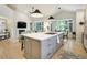 Open-concept kitchen and living room featuring a large island, fireplace, and plenty of natural light at 74 Blue Heron Dr, Greenwood Village, CO 80121