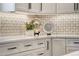 Close up of the renovated kitchen featuring backsplash and stainless steel appliances at 74 Blue Heron Dr, Greenwood Village, CO 80121