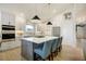 Modern kitchen features white cabinets, stainless appliances, an island, and a bright, open space at 74 Blue Heron Dr, Greenwood Village, CO 80121