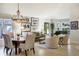Bright living room featuring a piano, large windows, and neutral decor at 74 Blue Heron Dr, Greenwood Village, CO 80121