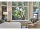 Bedroom with large windows overlooking the yard and views of the outside at 74 Blue Heron Dr, Greenwood Village, CO 80121