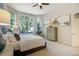 Sunlit main bedroom with scenic views, soft decor, and neutral tones at 74 Blue Heron Dr, Greenwood Village, CO 80121