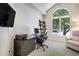 Home office with a desk, computer, shelves, and a comfortable chair near a large window at 74 Blue Heron Dr, Greenwood Village, CO 80121