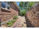 Side yard with rock landscaping and pathway leading to the backyard, enhancing the property's curb appeal at 74 Blue Heron Dr, Greenwood Village, CO 80121