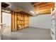 An unfinished basement with bare ceiling and shelving at 1637 S Stuart St, Denver, CO 80219
