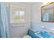 This bathroom has tile, a window, sink, and toilet at 1637 S Stuart St, Denver, CO 80219