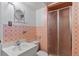 A bathroom featuring pink tile and glass shower at 1637 S Stuart St, Denver, CO 80219