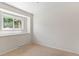 This bedroom has carpet and one window at 1637 S Stuart St, Denver, CO 80219