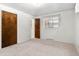 Bright bedroom boasts an exterior window, carpeting, and a closet for storage at 1637 S Stuart St, Denver, CO 80219