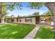 Beautifully landscaped home with a spacious yard and a covered patio area at 1637 S Stuart St, Denver, CO 80219