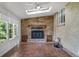 Sunroom featuring a brick fireplace, tiled floors, and large windows at 1637 S Stuart St, Denver, CO 80219