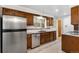 Well-lit kitchen features stainless steel dishwasher, double basin sink, and tiled backsplash at 1637 S Stuart St, Denver, CO 80219