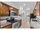 Efficient kitchen features updated stainless steel oven and microwave, ample cabinet space and marbled countertops at 1637 S Stuart St, Denver, CO 80219