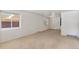 Bright living room features neutral carpet and walls, with large windows providing lots of natural light at 1637 S Stuart St, Denver, CO 80219