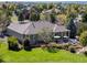 Aerial view of home with patio seating area and green lawn at 6449 E 163Rd Ave, Brighton, CO 80602