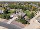 Wide aerial shot displaying the home, large lot, mature trees, and white fencing at 6449 E 163Rd Ave, Brighton, CO 80602