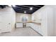 Clean unfinished basement with white cabinets and carpet at 6449 E 163Rd Ave, Brighton, CO 80602