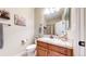 Charming bathroom featuring a framed mirror and a tiled shower with glass doors at 6449 E 163Rd Ave, Brighton, CO 80602