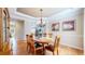 Elegant dining room with hardwood floors, a chandelier, and adjacent living spaces at 6449 E 163Rd Ave, Brighton, CO 80602