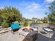 Outdoor stone fire pit with seating area in a beautifully landscaped backyard at 6449 E 163Rd Ave, Brighton, CO 80602