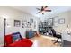 Another view of a bright office with wood floors, a blue desk, and a sitting area at 6449 E 163Rd Ave, Brighton, CO 80602