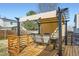 An outdoor deck with a patio dining set and a retractable shade at 2175 E 126Th Way, Thornton, CO 80241