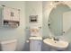 Cozy powder room boasts a round mirror and elegant fixtures for added convenience at 2175 E 126Th Way, Thornton, CO 80241