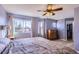 Serene bedroom with a large window, hardwood floors, and a ceiling fan at 2175 E 126Th Way, Thornton, CO 80241