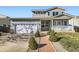 Charming two-story home featuring a two-car garage, inviting front porch, and landscaped front yard at 2175 E 126Th Way, Thornton, CO 80241
