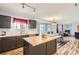 An eat-in kitchen is complete with wood floors, an island, and brown cabinets at 2175 E 126Th Way, Thornton, CO 80241