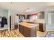 Modern kitchen featuring stainless steel appliances, a kitchen island, and light wood flooring at 2175 E 126Th Way, Thornton, CO 80241