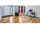 Bright living room with light wood flooring, complemented by red window coverings at 2175 E 126Th Way, Thornton, CO 80241
