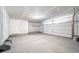 Spacious unfinished two-car garage with visible storage and high ceilings at 13625 E 103Rd Pl, Commerce City, CO 80022