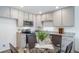 Modern kitchen with stainless steel appliances, granite countertops, and a cozy dining area at 13625 E 103Rd Pl, Commerce City, CO 80022