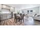 Bright living area features wood-look flooring and an open concept kitchen at 13625 E 103Rd Pl, Commerce City, CO 80022